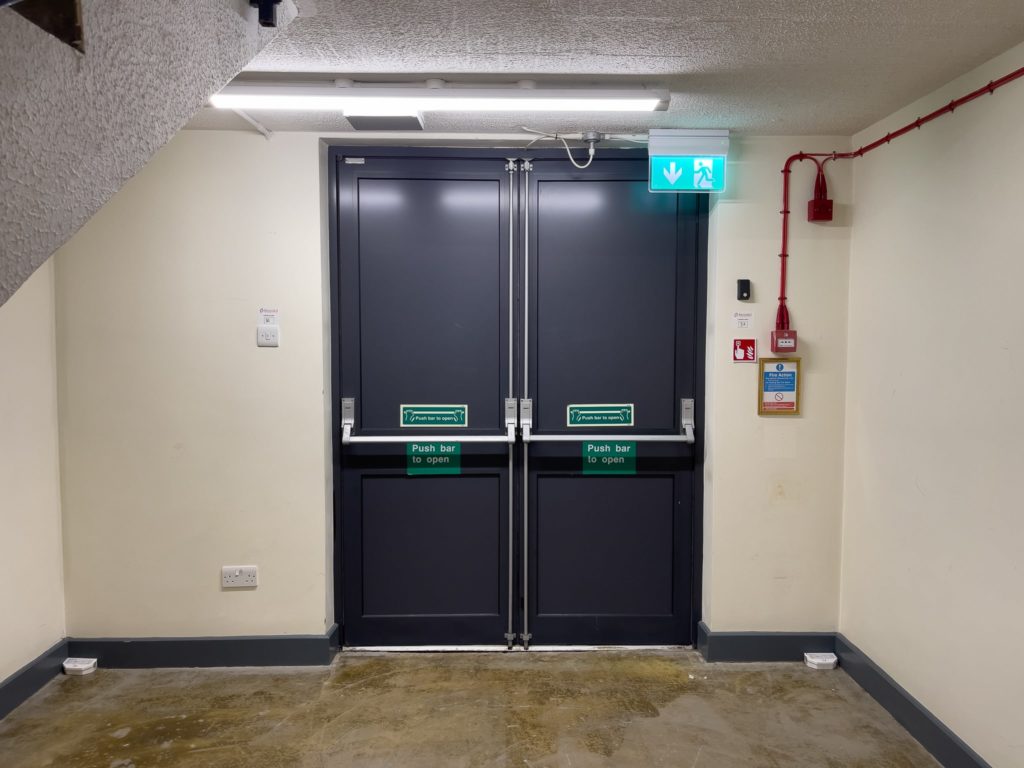 Modern residential block hallway with fire doors